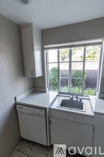 A bathroom with a tiled floor and a sink.
