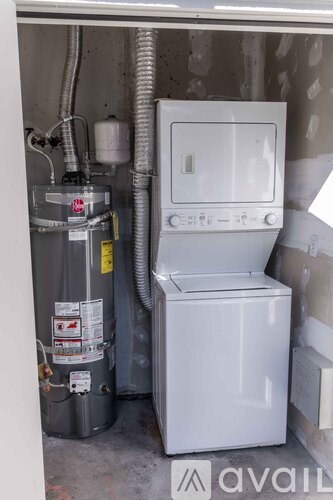 A room with wooden flooring and a window with blinds.