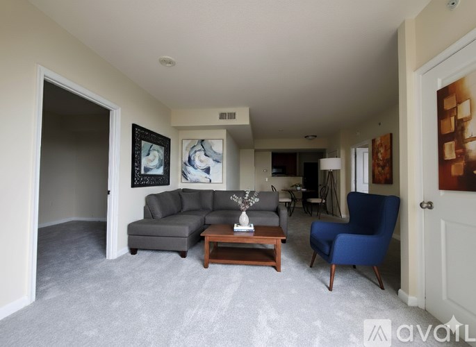 A spacious room with a carpeted floor and white walls.