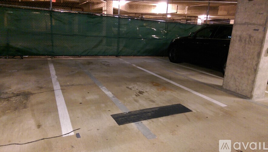 A black car is parked in a parking garage.