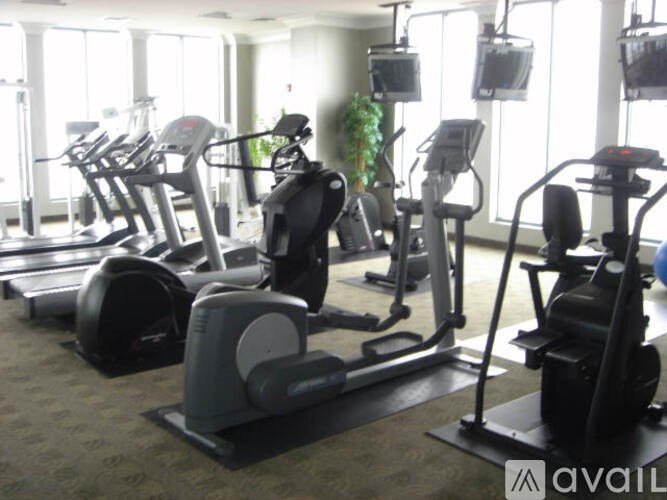 A gym with treadmills, exercise bikes, and other equipment.