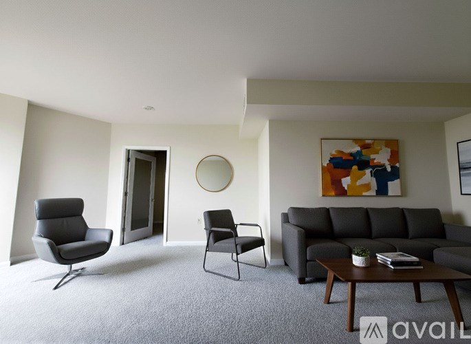 A room with a carpeted floor and a doorway leading to another room.