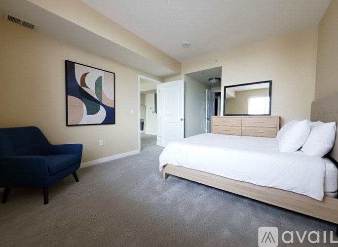 A room with a carpeted floor and a window with blinds.