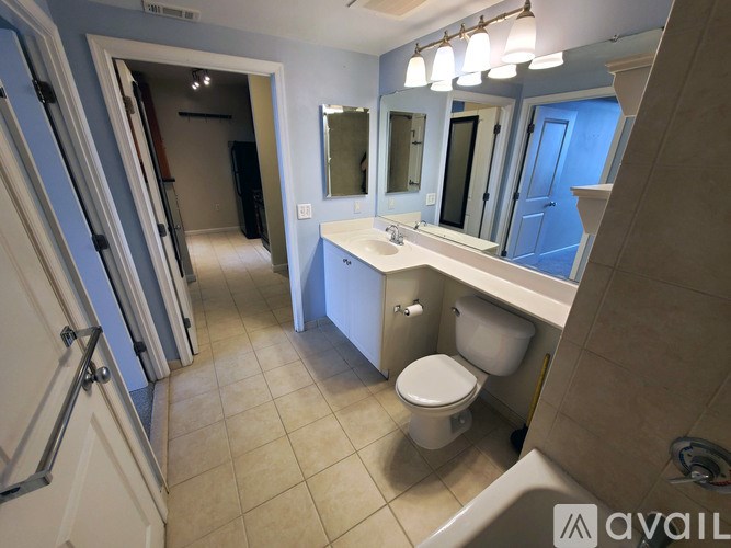 A living room with a fireplace, a chair, and a lamp.