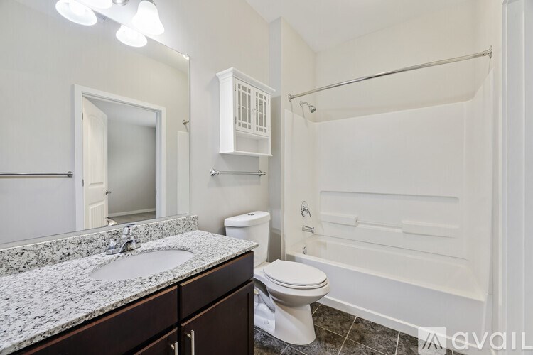 A bathroom with a sink, toilet, and bathtub.