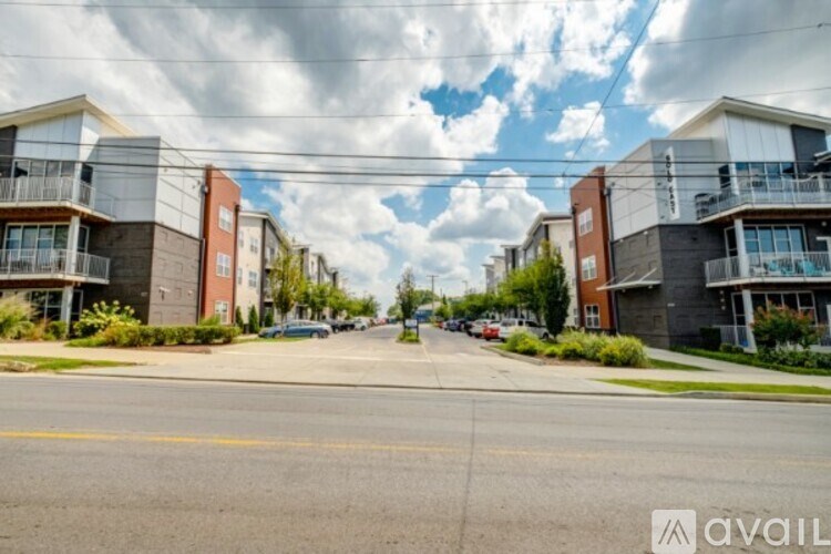 A street view of a residential area with apartment buildings on both sides.
