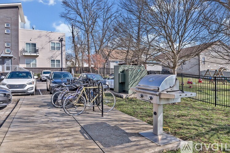 A row of bicycles is parked next to a mailbox on a sidewalk.
