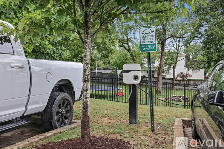 A sign in a yard that says Electric Vehicle Charging.