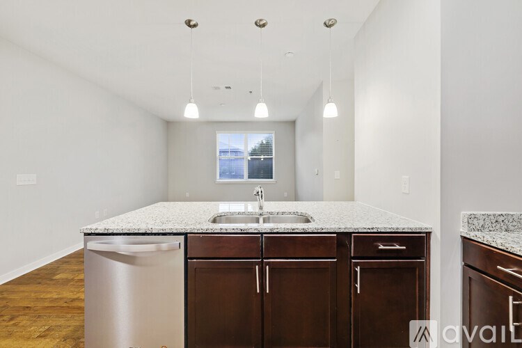 A kitchen with a granite countertop and stainless steel appliances.