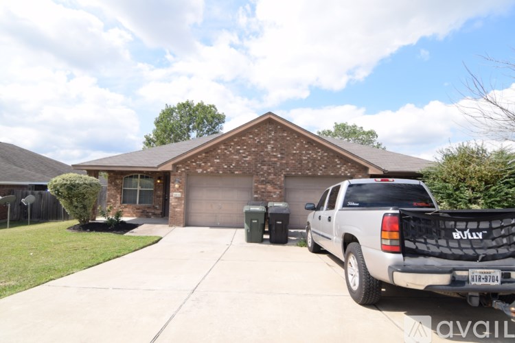 A house with a garage and a truck parked in front.