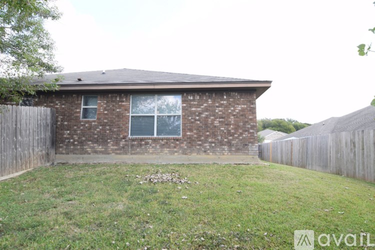 A brick house with a fence and a window.