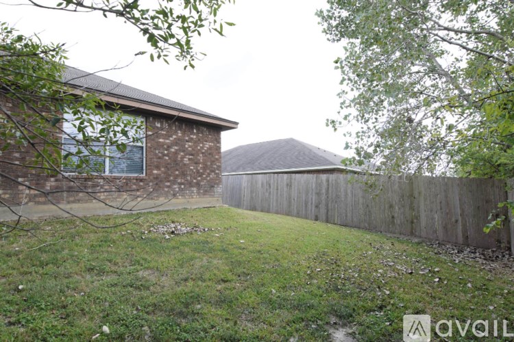 A house with a brown roof and a wooden fence.