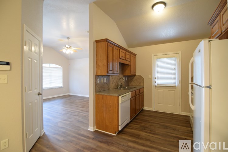A kitchen with wooden cabinets and a white refrigerator.