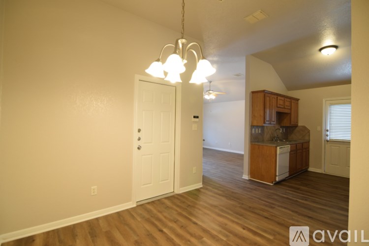 A room with a white door and a cabinet with a counter.