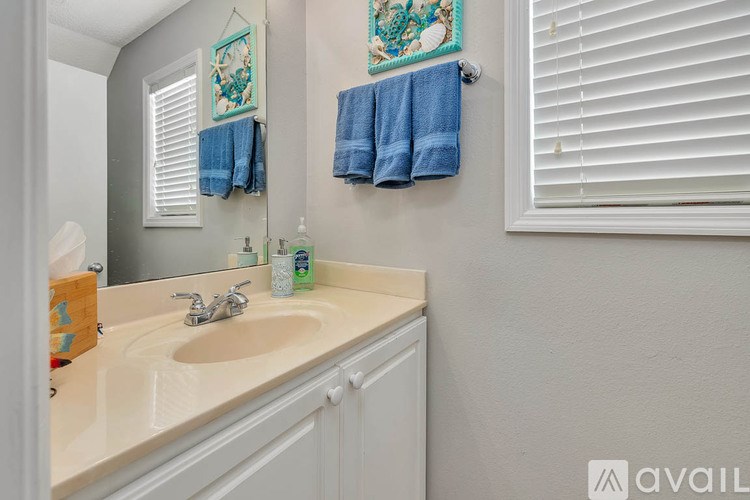A kitchen with a white refrigerator, a white stove, and brown cabinets.