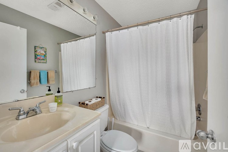 A room with a ceiling fan and wooden flooring.