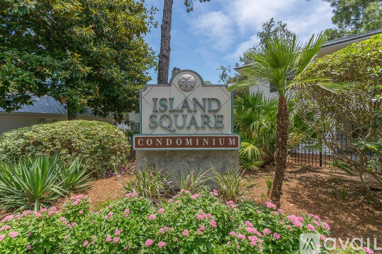 A living room with a fireplace and built-in shelves.