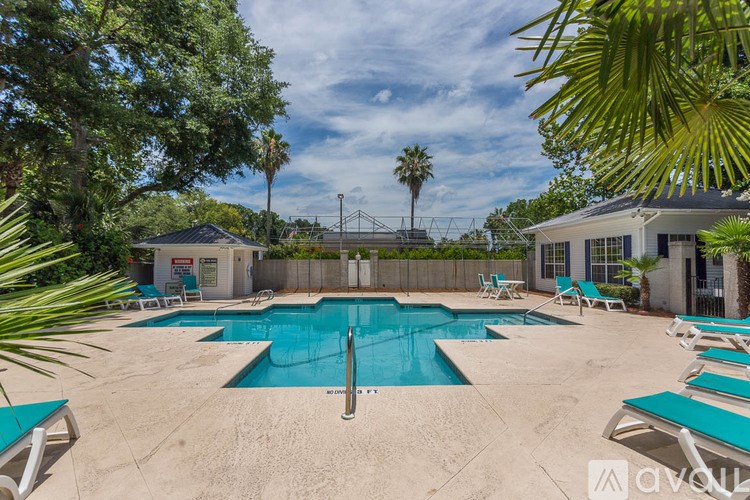 A living room with a fireplace and built-in shelves.