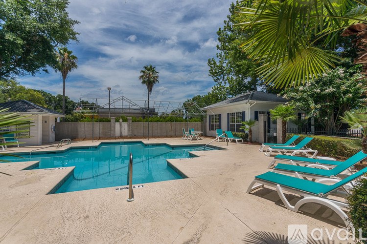 A living room with a fireplace and a staircase.
