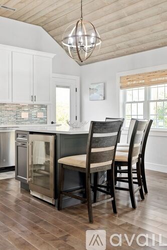 A kitchen with wooden floors and a wooden ceiling.