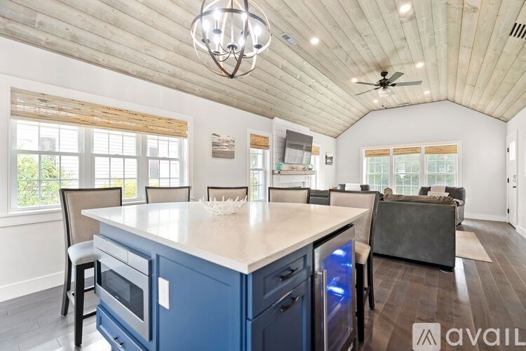 A kitchen with blue cabinets and a white island.