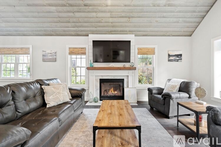 A modern living room with a fireplace and a television.