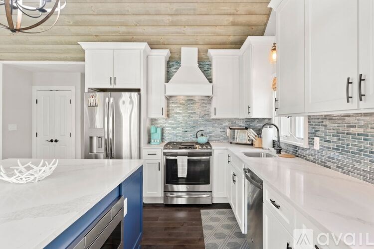 A kitchen with white cabinets and a blue drawer.