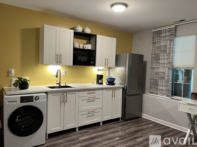 A white toilet sits in a bathroom with brown tile flooring.