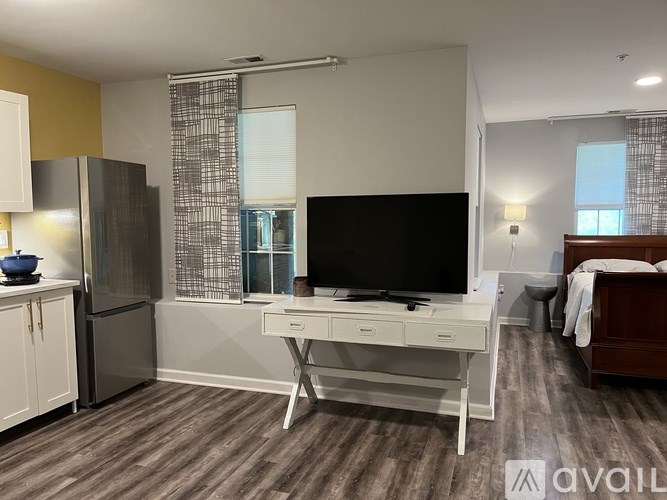 A room with a desk and a chair in it.