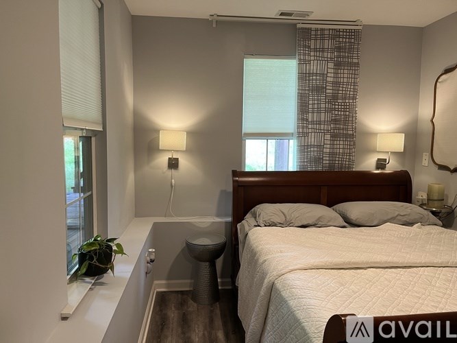 A bathroom with a marble countertop and a white bathtub.