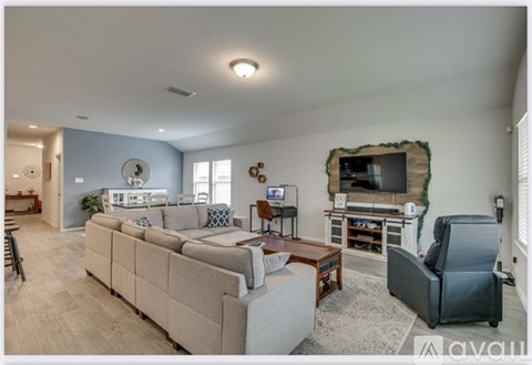 A living room with a grey sofa and a television.