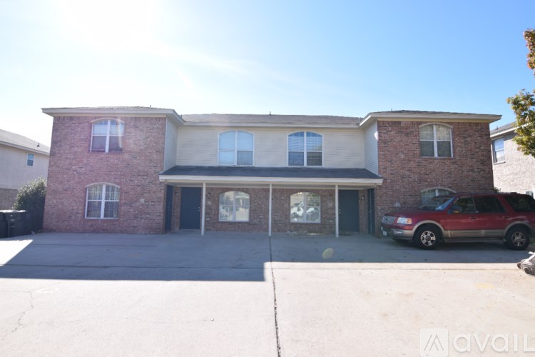 A house with a red car parked in front.