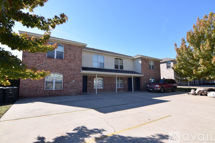A building with a parking lot in front of it.