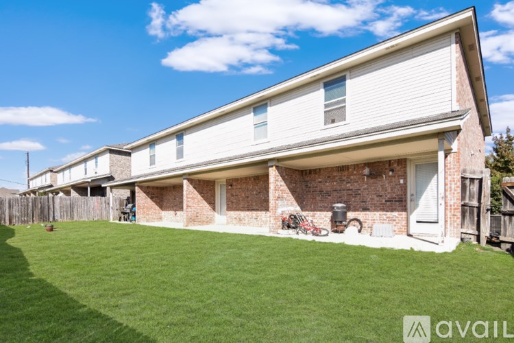 A white toilet in a bathroom with a sink and mirror.