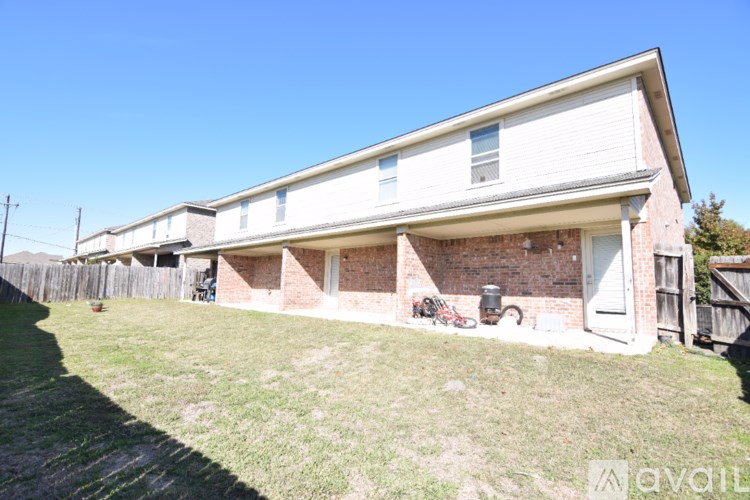 A house with a white garage door and a brick wall.