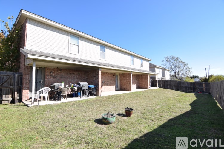 A house with a patio and a lawn.