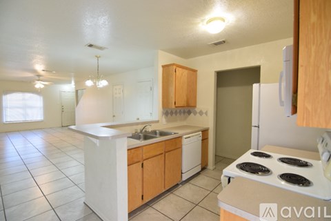 A kitchen with white appliances and wooden cabinets.
