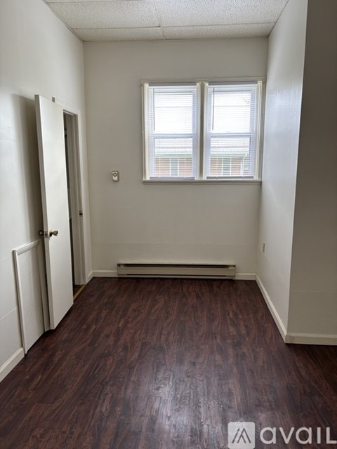 A room with a window and a door.