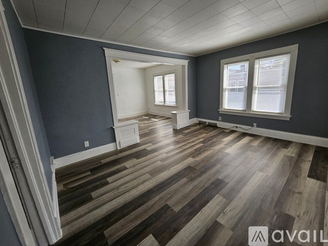 A room with wooden flooring and a window.