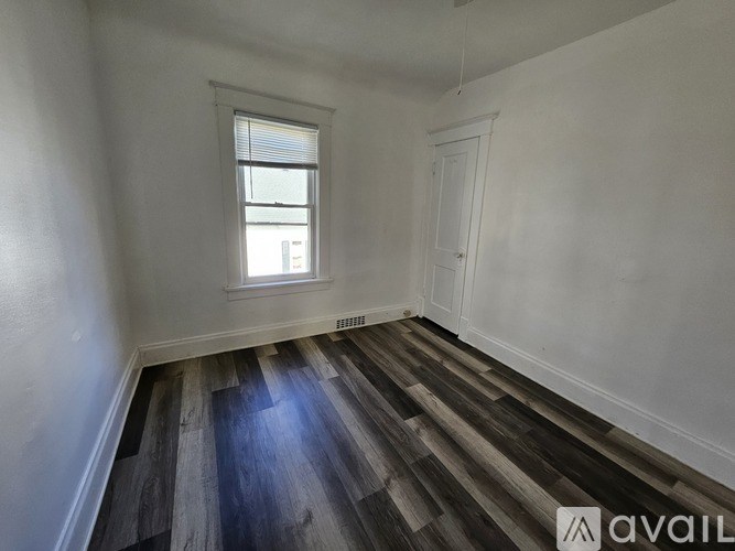 A room with wooden floors and a window.