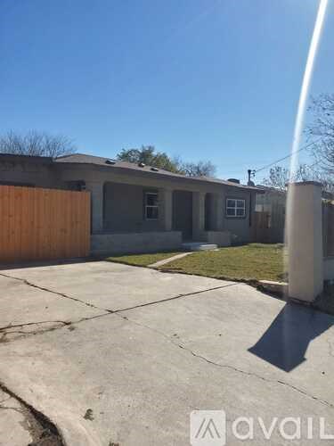 A house with a brown fence and a grey roof is shown.