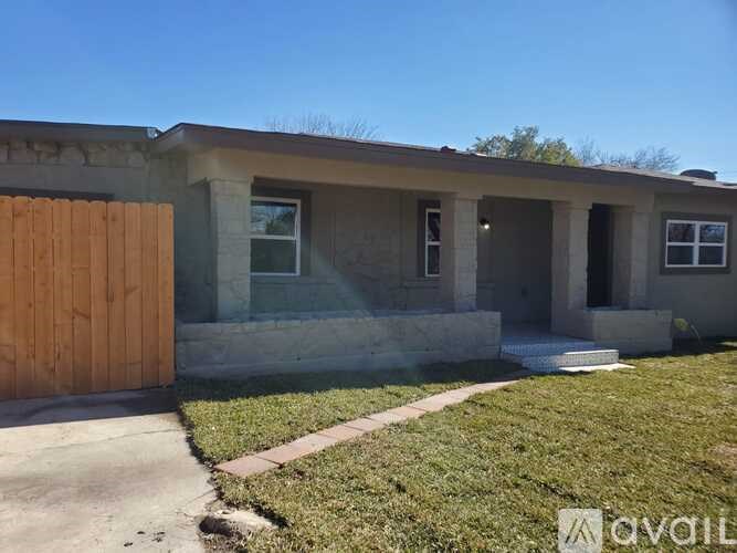 A house with a brown door and a concrete wall.