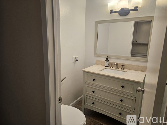 A bathroom with a toilet, sink, and shower.