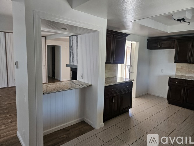 A bathroom with a sink, mirror, and light fixture.