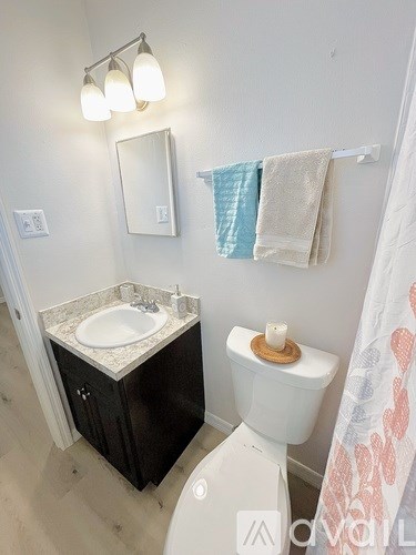 A white toilet sits next to a sink in a bathroom.