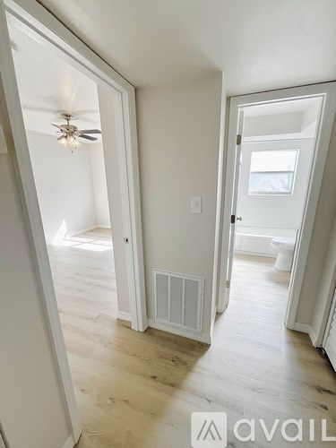 A room with a ceiling fan and a window.