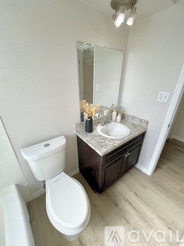 A white toilet sits next to a sink in a bathroom.