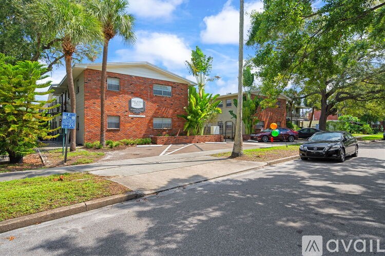 A black car is parked on the side of a street.