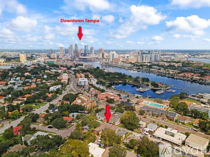 A bird's eye view of Downtown Tampa with two red arrows pointing to specific areas.