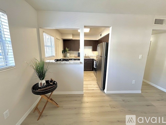 A kitchen area with a table and a plant on it.